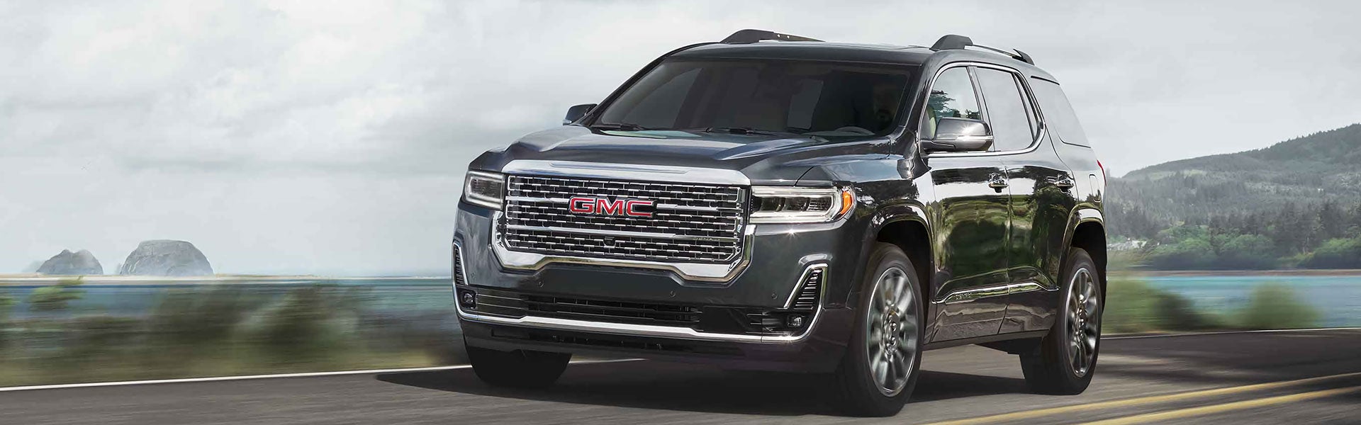 GMC Black Acadia running on road