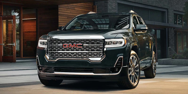 Black Acadia parked front of building