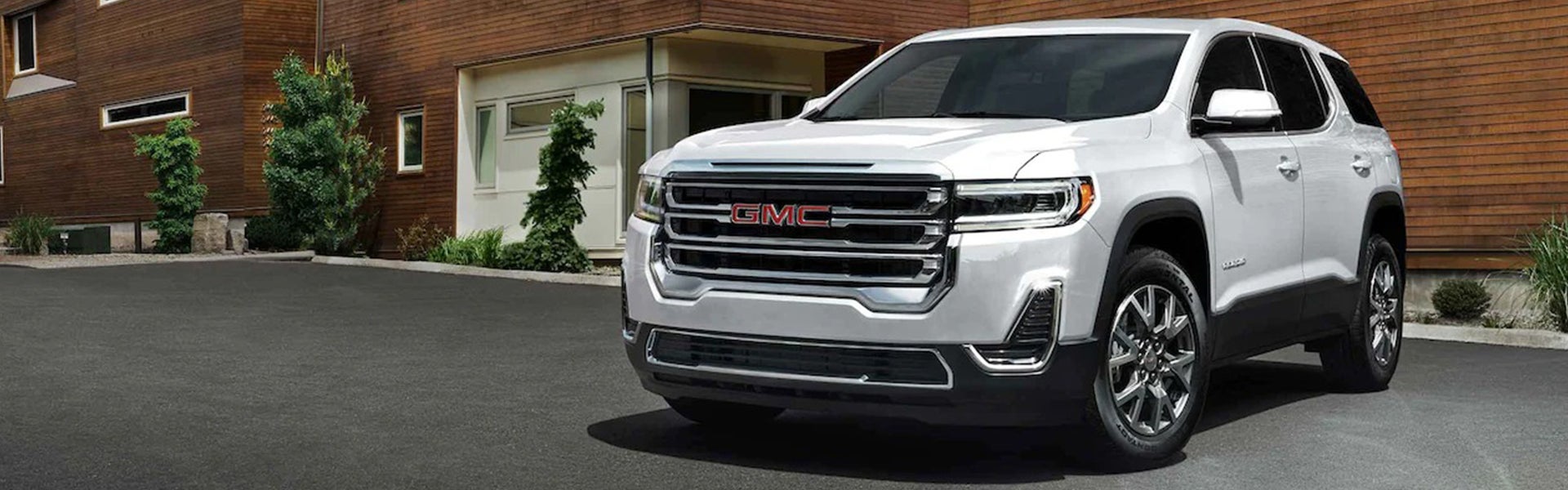 White GMC Acadia Parked front of building