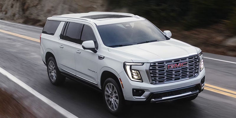2026 GMC Yukon driving on a scenic highway