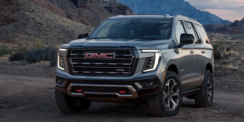 2026 GMC Yukon AT4 parked on a scenic mountain road